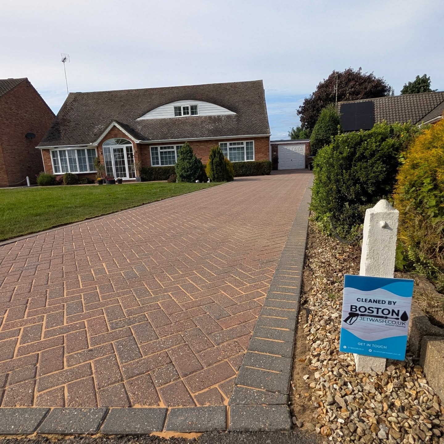 A clean driveway with a Boston Jet Wash sign.
