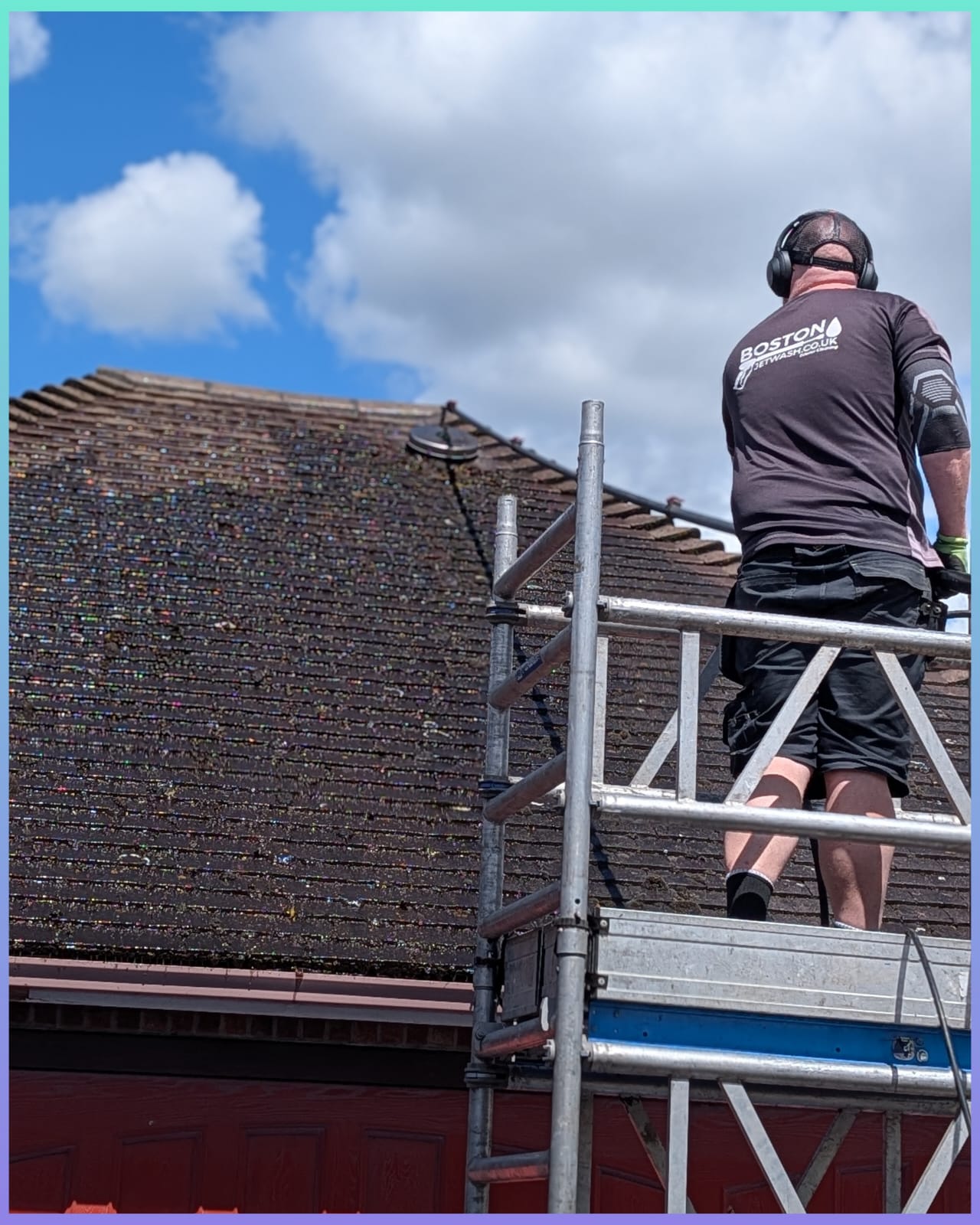 A roof being cleaned in Lincolnshire, by a man with a Boston Jet Wash uniform.